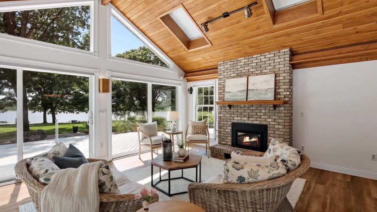Living room with a wall of glass facing the water at 8211 River Acres Road, Cottage Grove, Minnesota