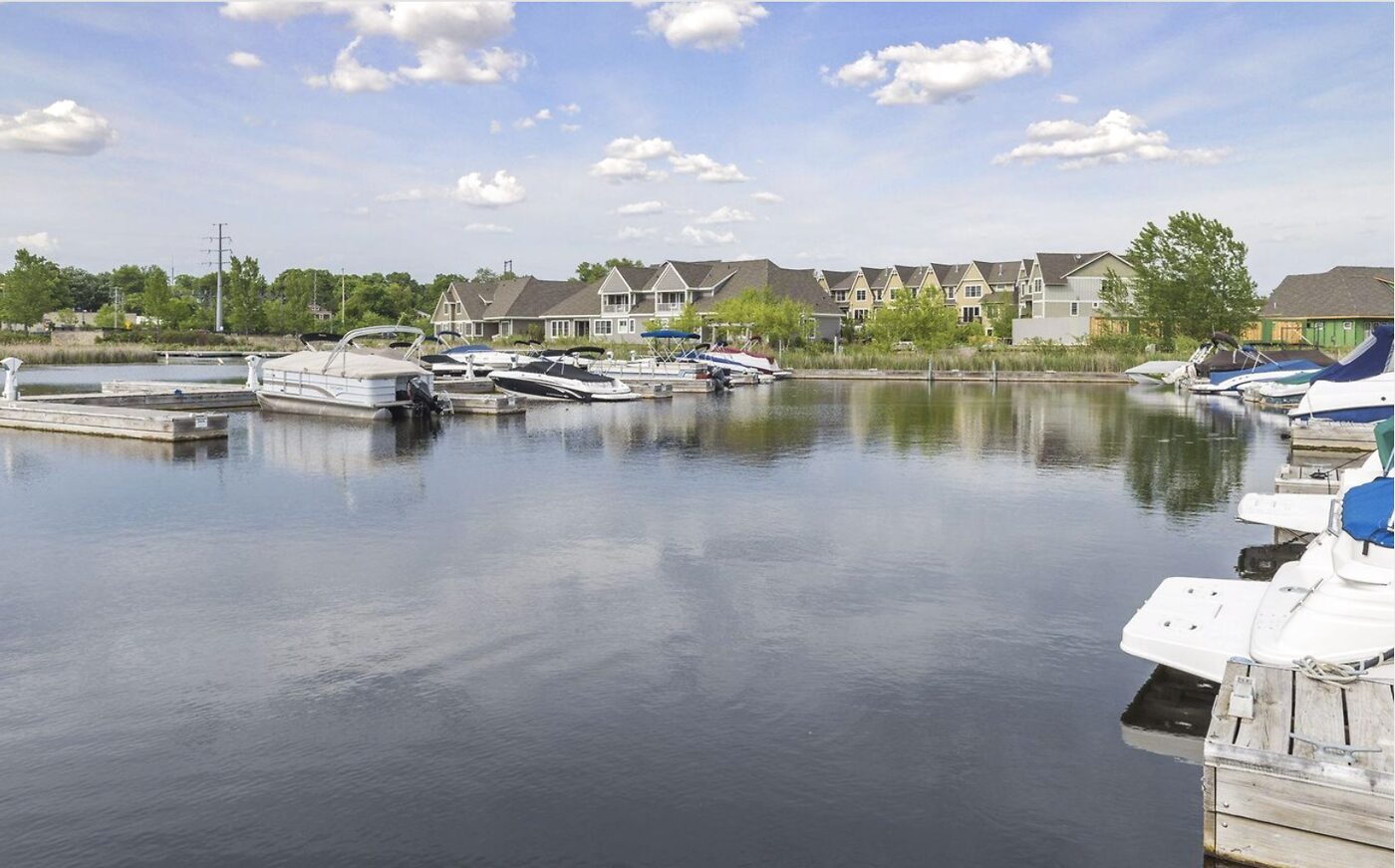 City dock slips at The Villas on Lost Lake with boats moored, showing the licensed slips that come with the townhomes