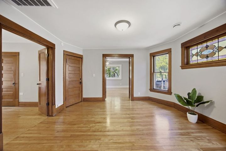 Upper unit living room with stained glass in the bay