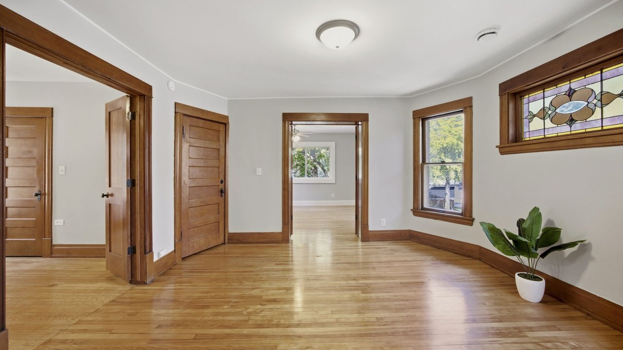 Upper unit living room with original stained glass