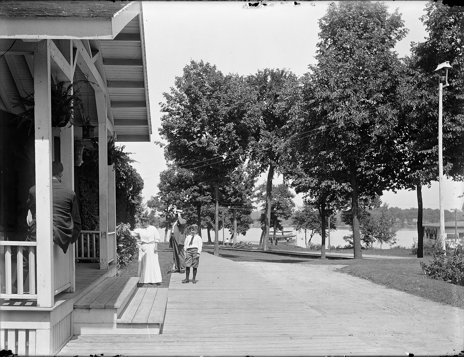Vacationers on the Tonka Bay Hotel boardwalk
