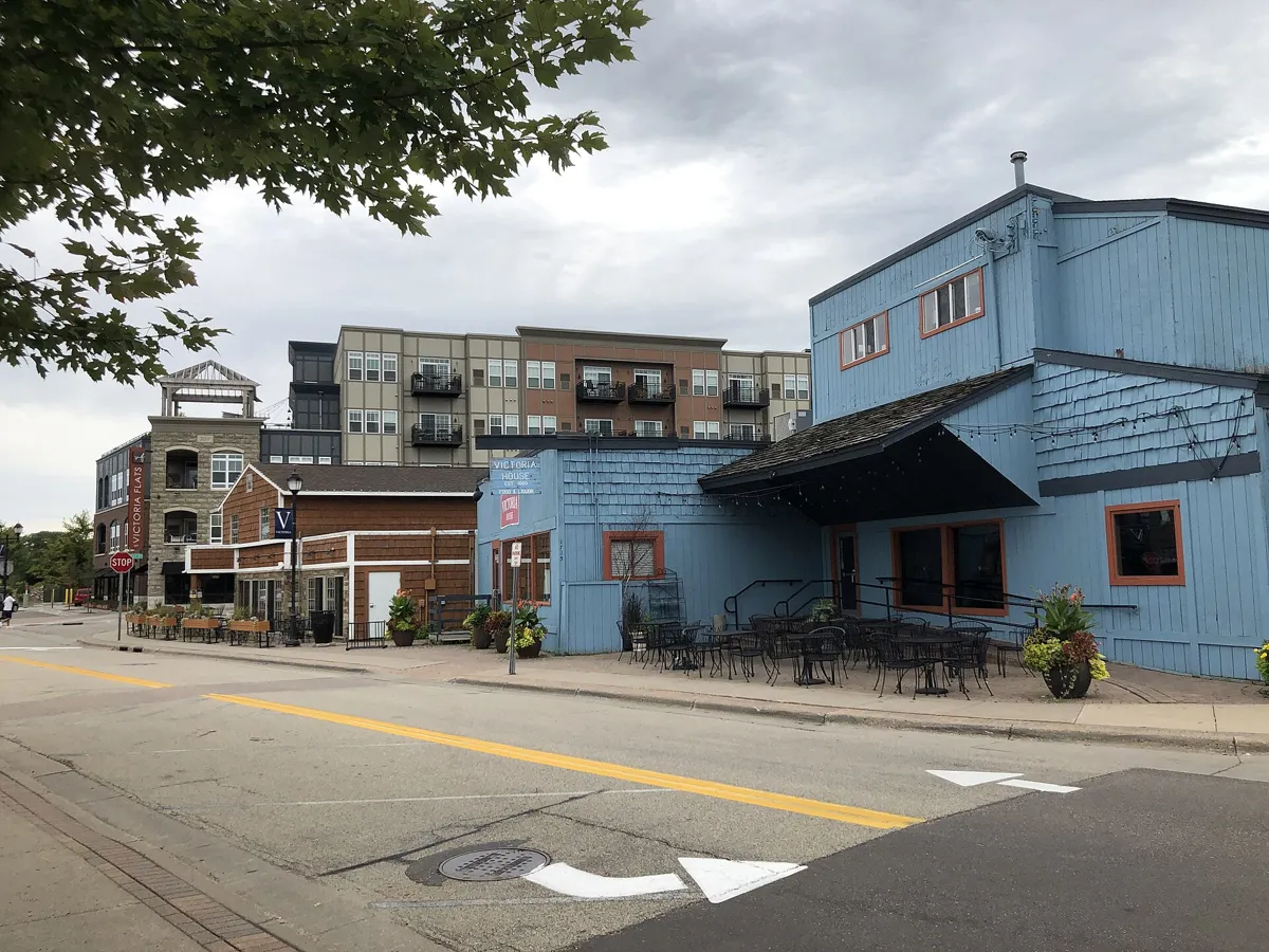 Shops and newer apartment buildings along a downtown Victoria street