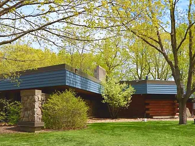 The low wood and stone Lowry Nature Center building in summer