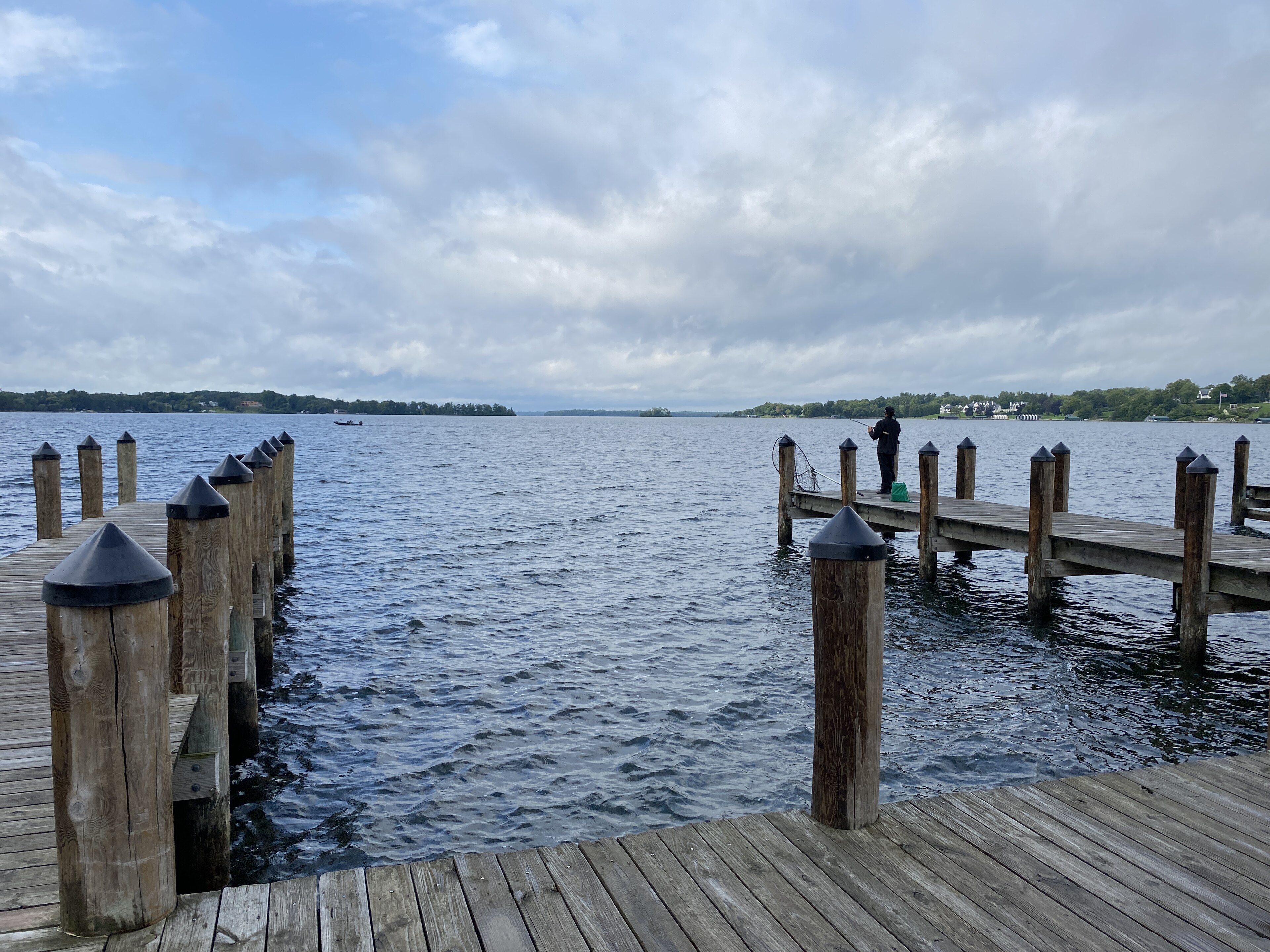 Wooden docks on Wayzata Bay with an angler