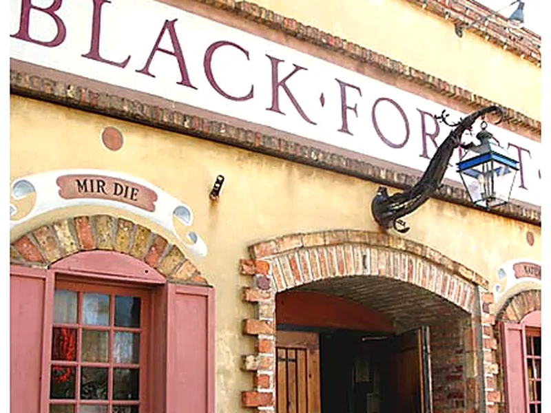 The Black Forest Inn sign and brick arched entrance