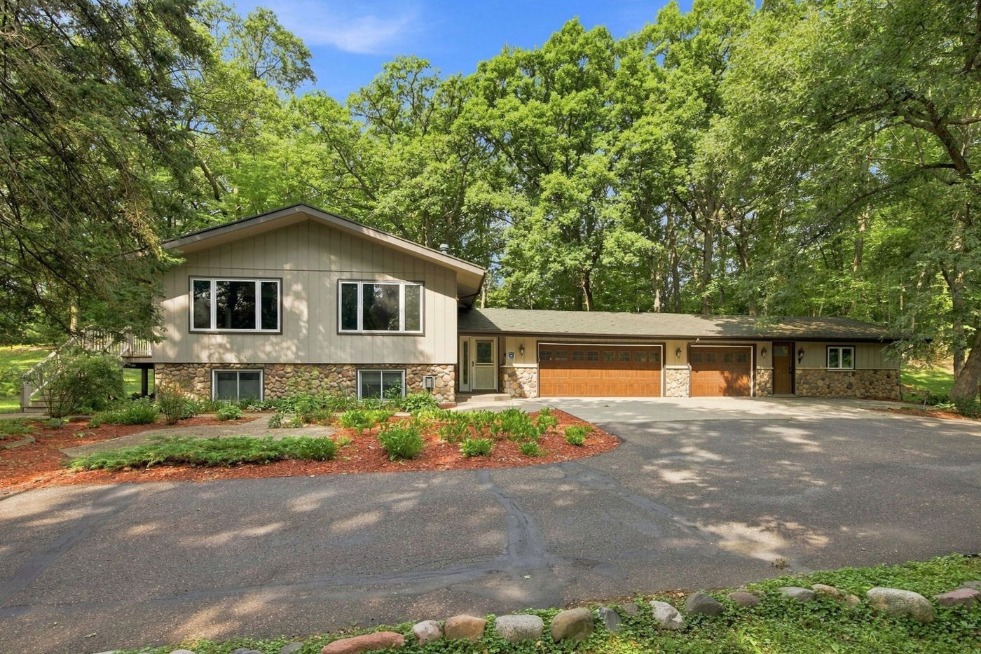 The home exterior, set among mature trees