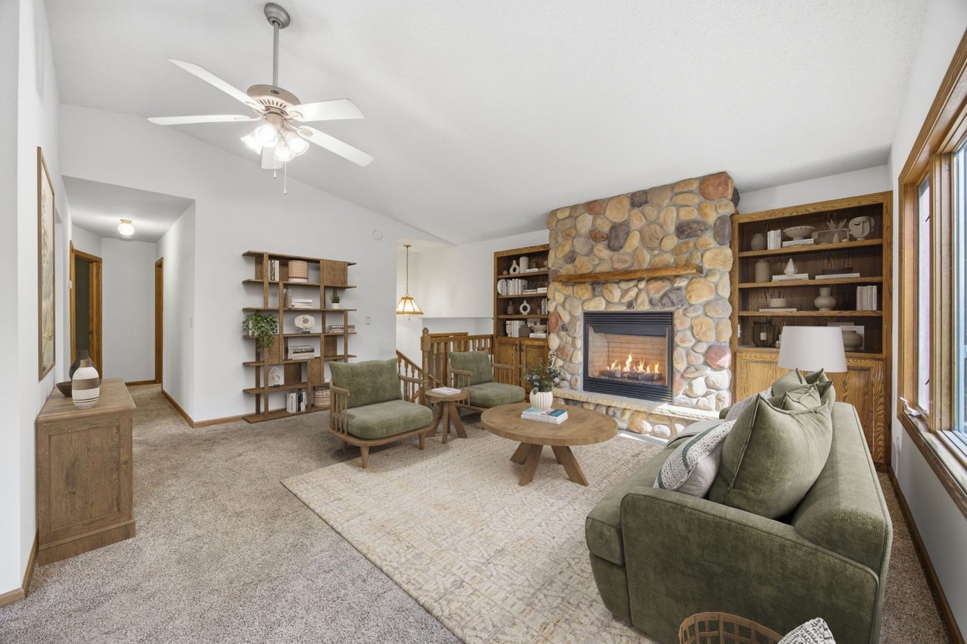 Living room with stone fireplace and built-ins